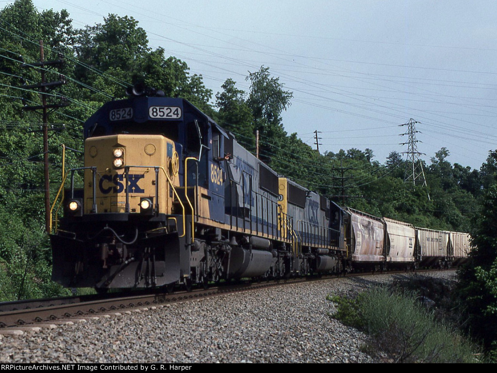 CSX 8524 leads a grain train eastbound.  Nice V sign from conductor.